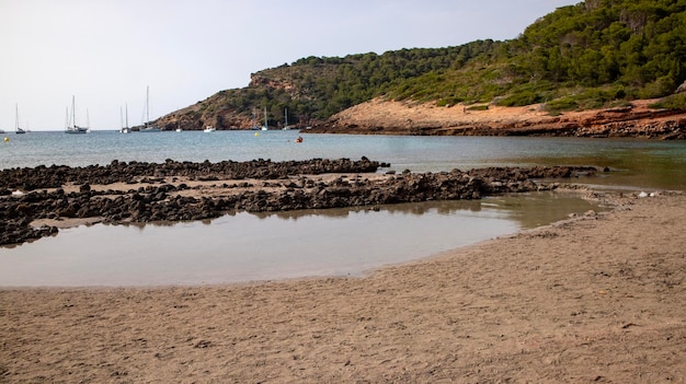 Uma praia com um pequeno barco na água