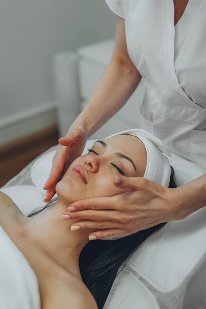 Uma rapariga num consultório de cosmetologistas a limpar a pele.