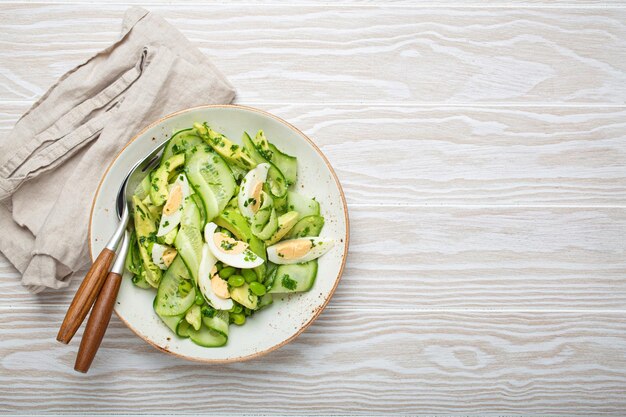 Uma saudável tigela de salada de abacate verde com ovos cozidos em fatias