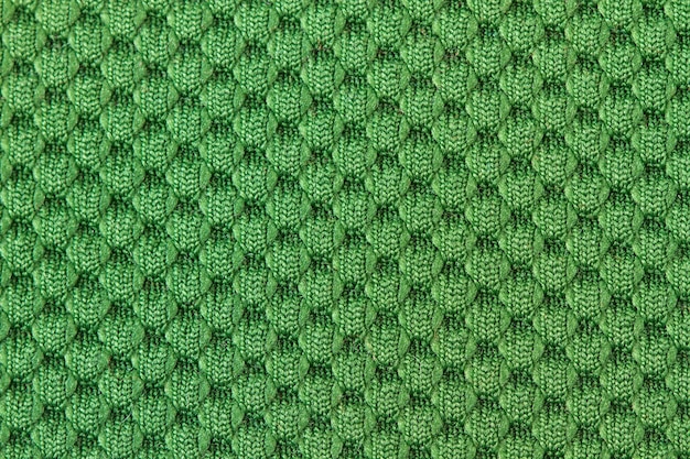 Uma textura de pano de lã verde em uma visão de perto