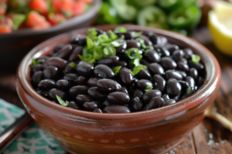Foto uma tigela de feijão preto com alguns outros alimentos