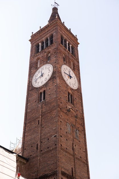 Uma torre de relógio velha de tijolos na cidade de itália