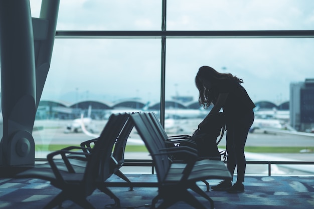 Uma viajante preparando e fazendo as malas no aeroporto