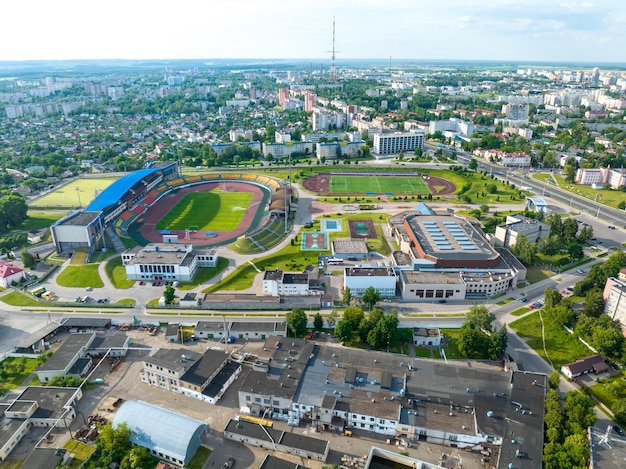 Uma visão panorâmica da cidade Voando um drone sobre a cidade durante o dia Vista de um grande complexo esportivo e um estádio de futebol de uma altura