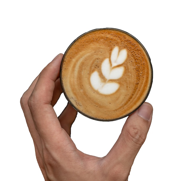 Uma xícara de café com um desenho no topo.