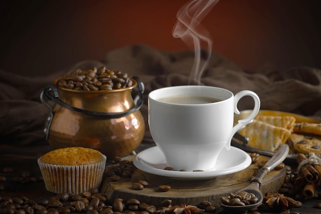 Uma xícara de café e muffins estão sobre uma mesa com uma xícara de café.