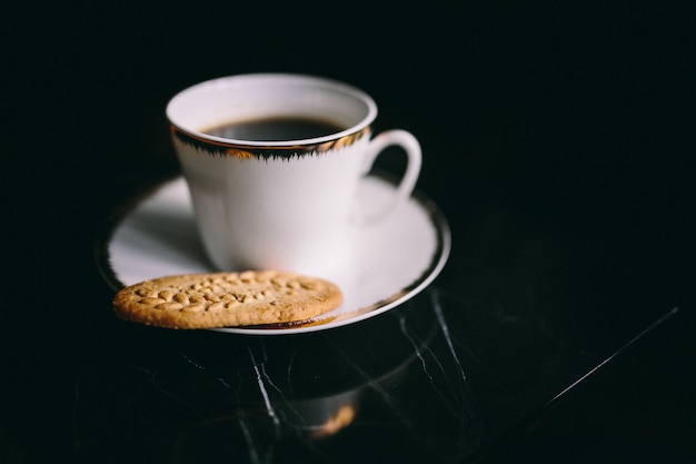 Foto uma xícara de café e um biscoito