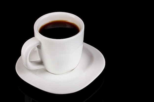 Uma xícara de café forte isolada em preto