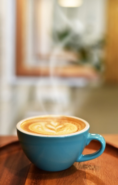 Uma xícara de café quente com padaria na mesa de madeira