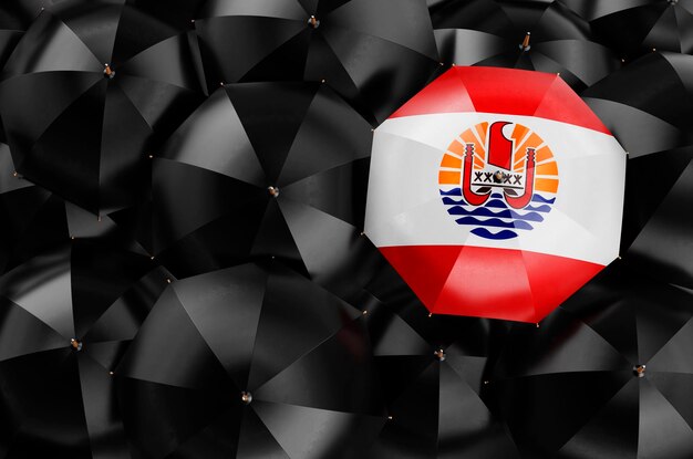 Umbrela com bandeira da Polinésia Francesa entre guarda-chuvas pretos vista superior renderização 3D