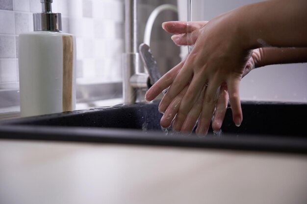 unerkennbare Frau, die sich die Hände wäscht. Hygiene beginnt mit den Händen.