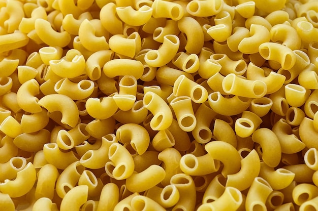 Ungekochte italienische Pasta-Hintergrund Ellenbogen-Makkaroni mit glatter Oberfläche