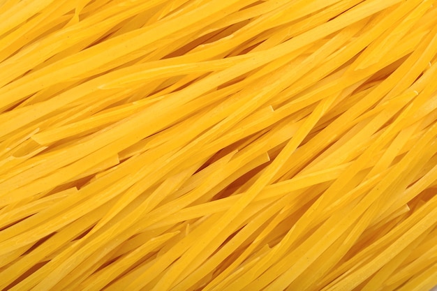 Ungekochte italienische Pasta-Tagliatelle als Hintergrundtextur