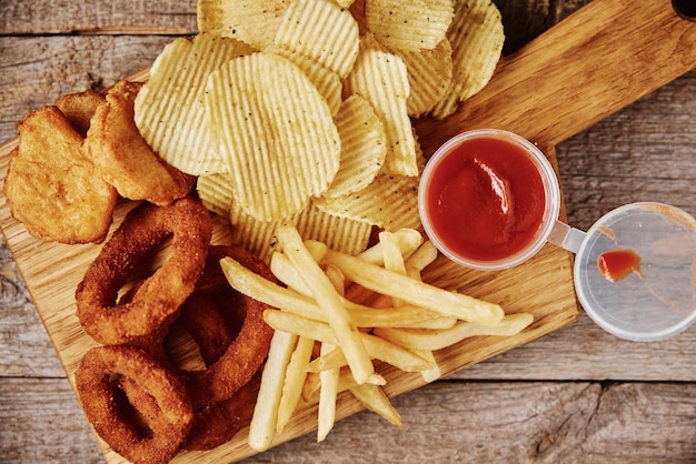 Ungesundes und Junk Food. Verschiedene Arten von Fastfood und Snacks auf dem Tisch, hautnah. Essen zum Mitnehmen