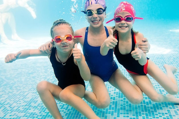 Unterwasserfoto von jungen Freunden im Schwimmbad.