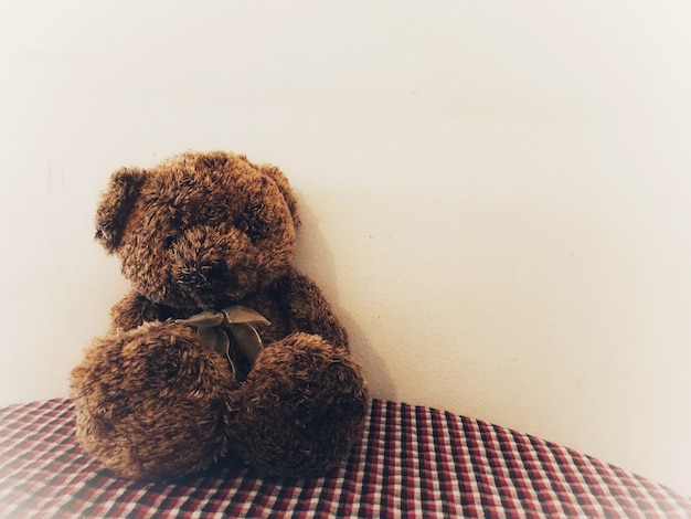 Foto urso de peluche solitário que espera alguém para abraçar com esperança.