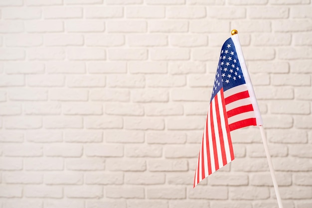 USA Memorial Day Presidents Day Veterans Day Labor Day oder 4. Juli Feier USA Nationalflagge auf weißem Backsteinmauerhintergrund mit Kopierraum