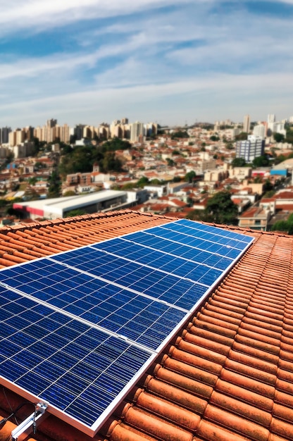 Foto usina fotovoltaica no telhado de um edifício residencial em dia ensolarado - conceito de energia solar de recursos sustentáveis