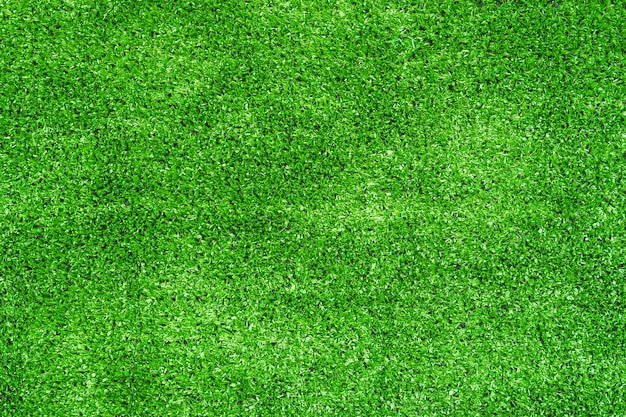 Uso de la hierba artificial de la decoración verde para el fondo del deporte.