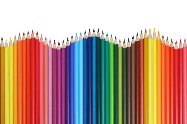 Útiles escolares lápices de colores formando una ola