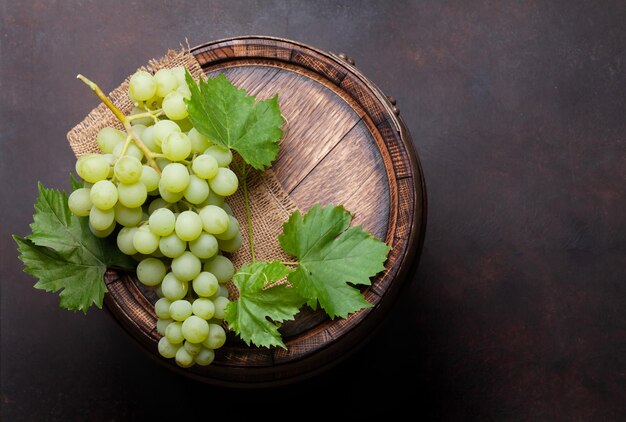 Uva blanca en el viejo barril de vino de madera Vista superior plana con espacio de copia