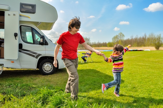 Vacaciones familiares, viaje en autocaravana con niños, feliz padre con niño se divierte en viaje de vacaciones familiares en autocaravana