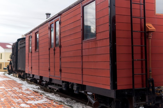 Vagão de carga vintage com locomotiva a vapor na estação no inverno