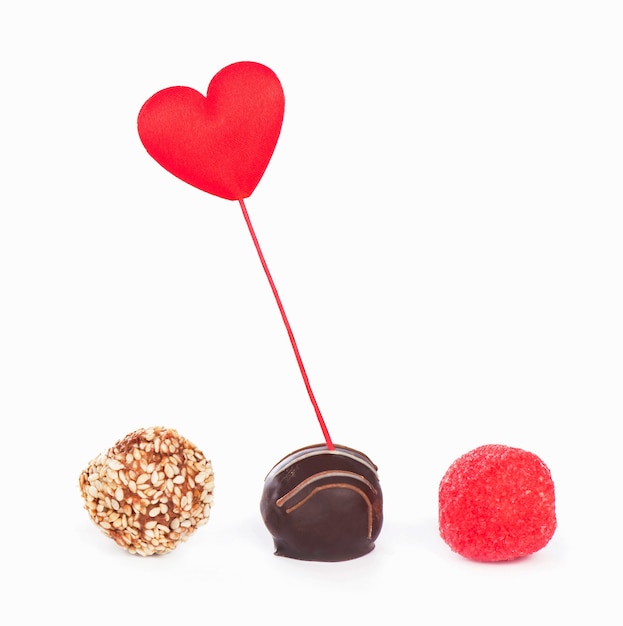 Valentinstag. Geschenkbox und Süßigkeiten in Form eines Herzens auf weißem Hintergrund