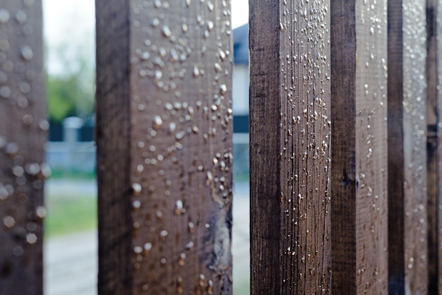 Valla de madera con gotas de agua después de la lluvia