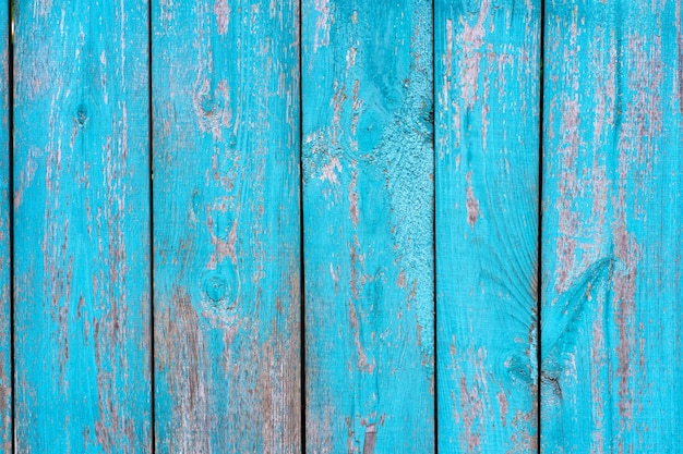 Valla de madera vieja textura de tablero pelado de pintura azul. Antecedentes.