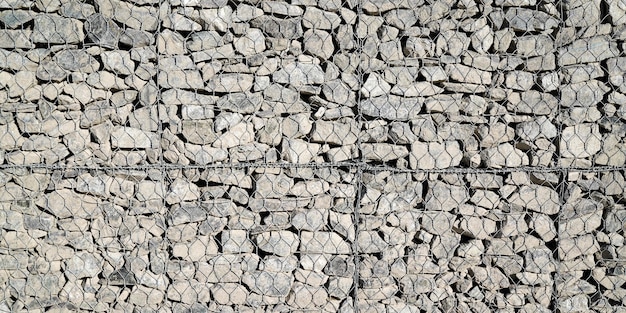 Valla con textura de piedra malla piedras fondo pared exterior fachada horizontal