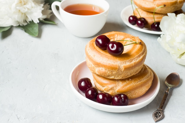 Vanillepudding backt Ring mit Kirsche auf einer Platte auf Grau zusammen