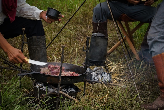 Foto el vaquero acampa al aire libre y prepara comida por la mañana.