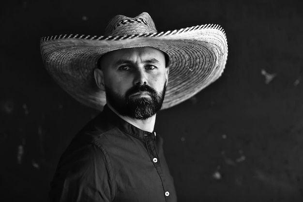 vaquero severo en un sombrero con ala, paja, estilo retro vintage, hombre enojado salvaje oeste occidental