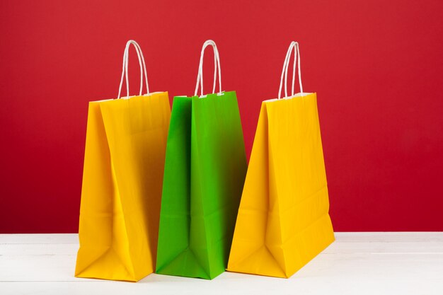 Varias bolsas de la compra con copia espacio sobre fondo rojo.