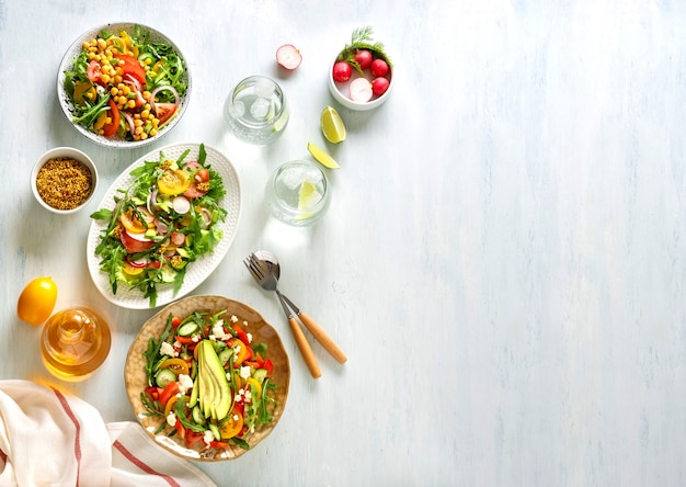 Varias ensaladas de verduras saludables de verano con aguacate, pepino, rábano, pimiento y tomate. Comida sana Vista superior.