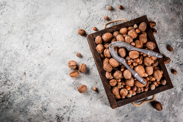 Varias nueces y cascanueces en caja de madera