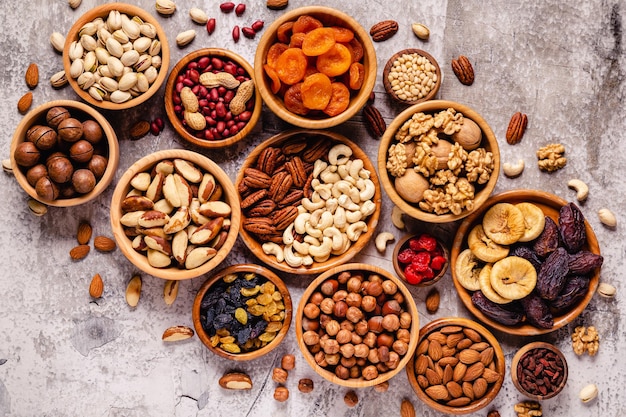 Varias nueces y frutos secos en tazones de madera