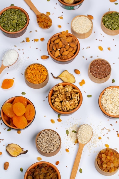 Una variedad de alimentos que incluyen garbanzos, almendras y otros alimentos están sobre un fondo blanco.