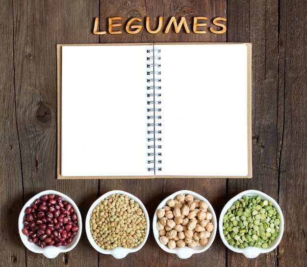 Variedad o legumbres, la palabra de las legumbres en una mesa de madera marrón vista superior con espacio de copia de cuaderno