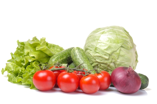 Variedad de verduras frescas sobre fondo blanco.