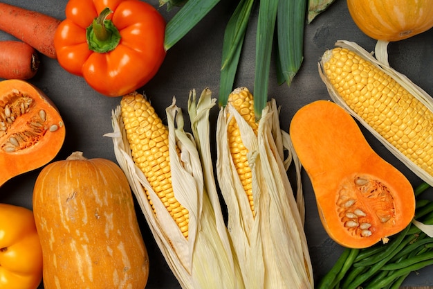 Variedad de verduras maduras como calabaza y maíz.