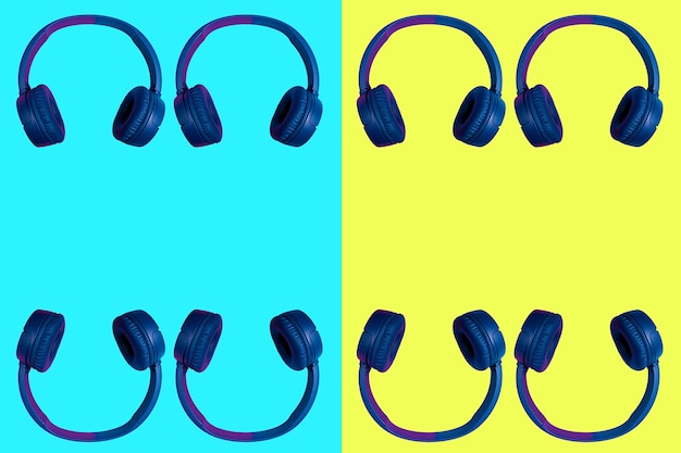 Varios auriculares inalámbricos dobles sobre un fondo de dos colores vivos en cian y amarillo. Estilo minimalista plano. Diseño y colores