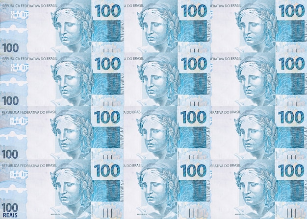 Foto varios billetes de cien reales de brasil, textura de dinero brasileño, notas de superficie de reales