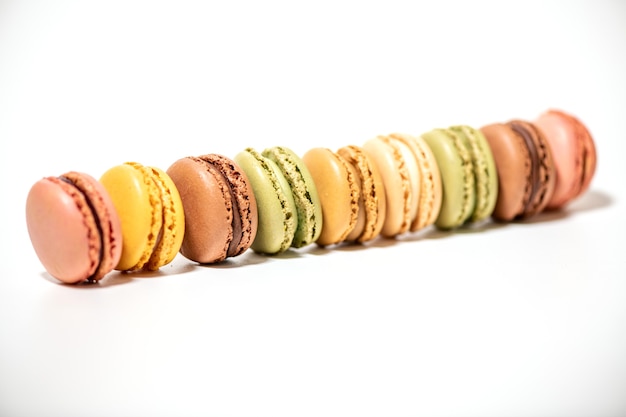 Vários bolos de macaron multicoloridos em uma superfície branca