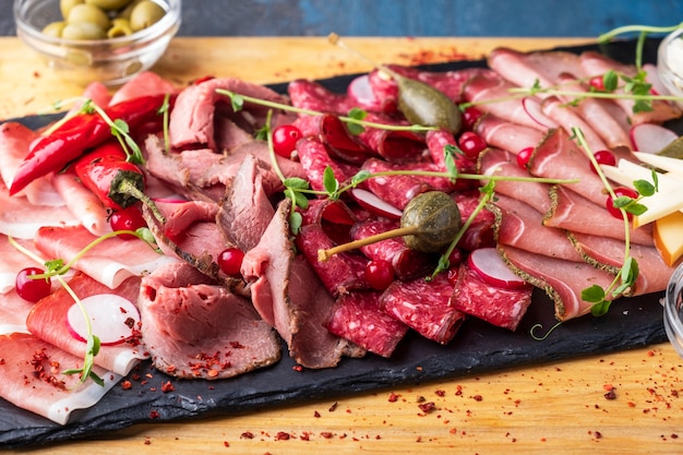 Varios de carne en una mesa de piedra negra