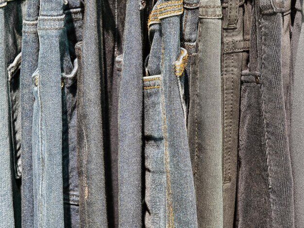 Various styles of denim jeans displayed in a clothing store for fashion enthusiasts shopping in the