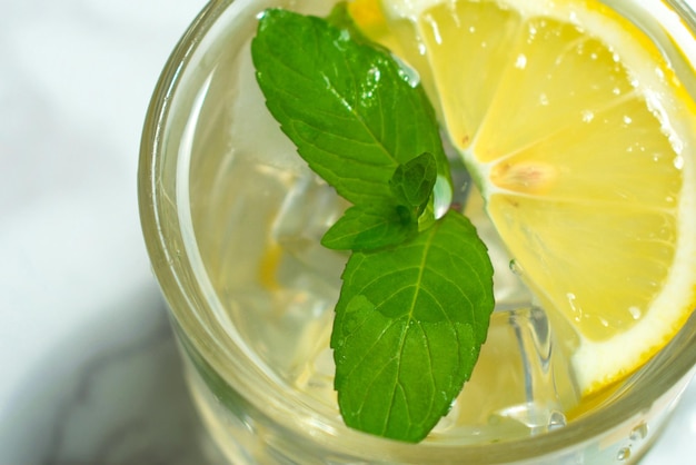 Un vaso de agua con limón y menta y hielo Bebida refrescante Vista desde arriba