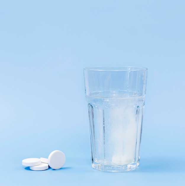 Vaso de agua con tabletas efervescentes y espacio de copia