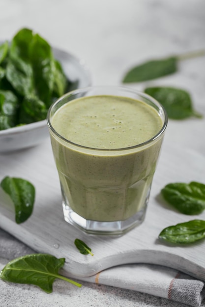 Vaso de batido verde saludable casero con espinacas frescas